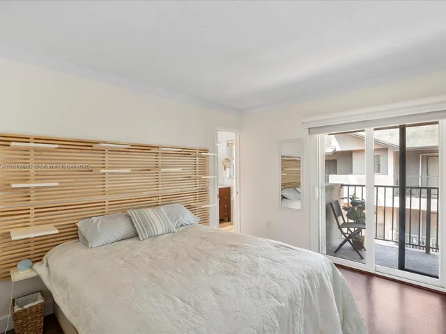 a bedroom with a large bed and a large window