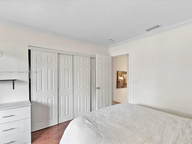 a view of a livingroom with wooden floor and closet