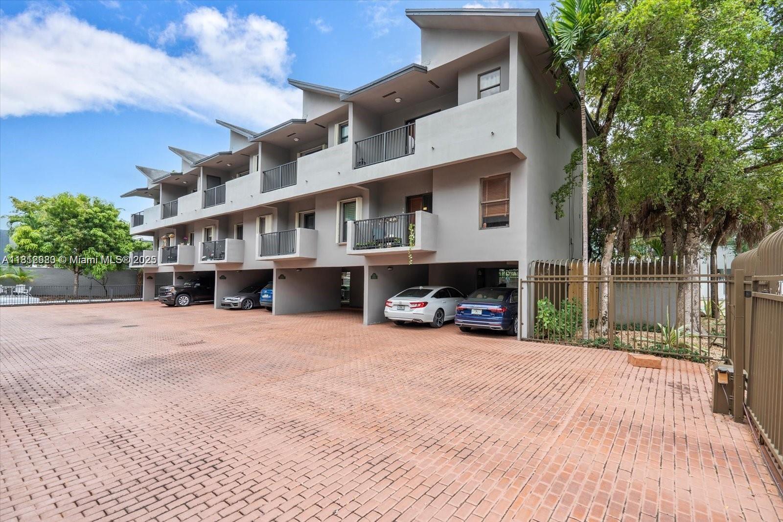 3097 Bird Avenue, Unit 3097 Miami, FL 33133 - Photo 2 of 29 a view of a car park in front of house