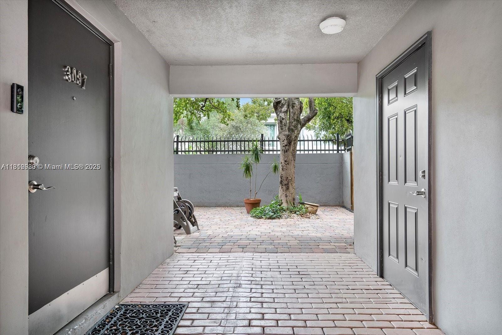 3097 Bird Avenue, Unit 3097 Miami, FL 33133 - Photo 22 of 29 a view of a hallway to a livingroom with wooden floor and a rug