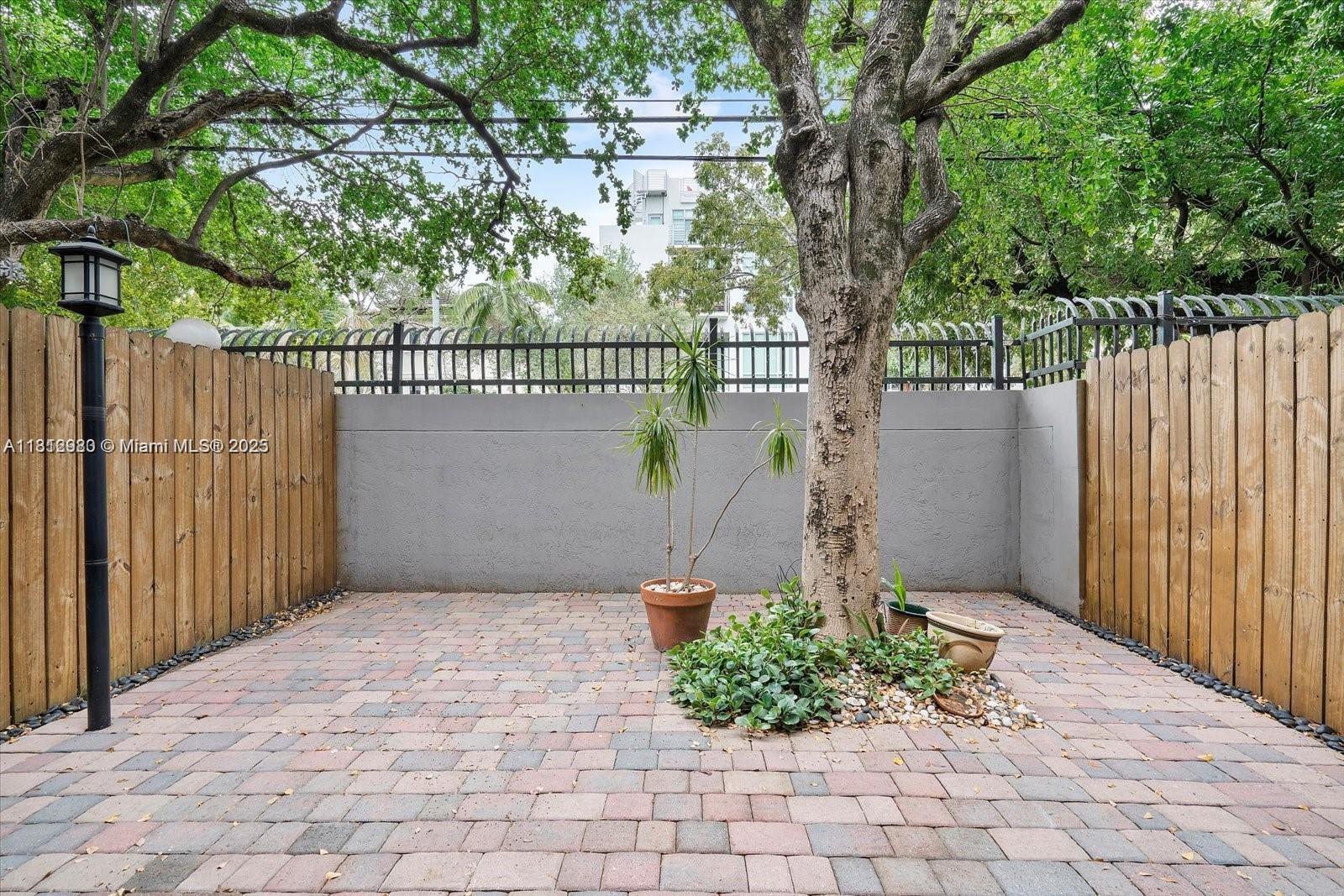 3097 Bird Avenue, Unit 3097 Miami, FL 33133 - Photo 23 of 29 a view of a pathway of a house with wooden fence