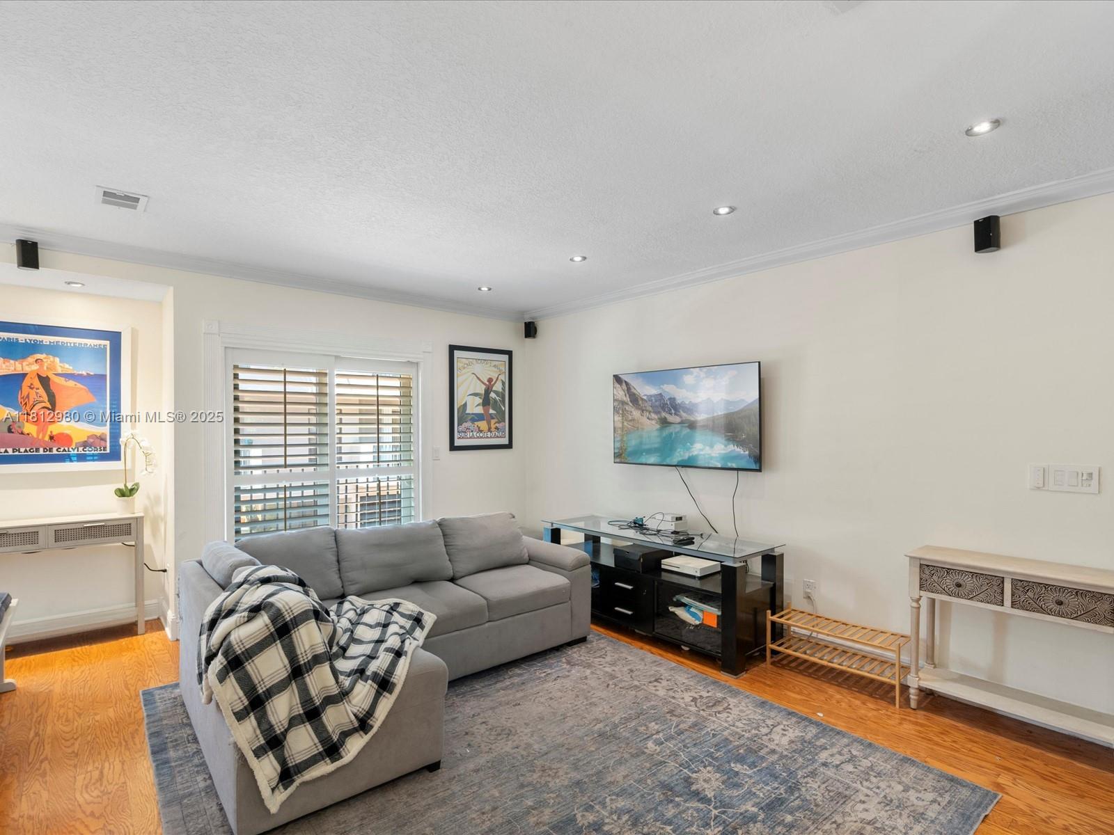 3097 Bird Avenue, Unit 3097 Miami, FL 33133 - Photo 3 of 29 a living room with furniture and a flat screen tv