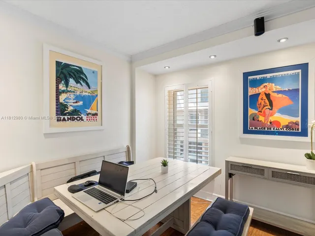 a view of a workspace with furniture and window