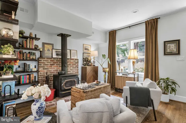 a living room with fireplace furniture and a flat screen tv