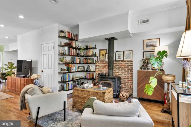 a living room with furniture and a bookshelf