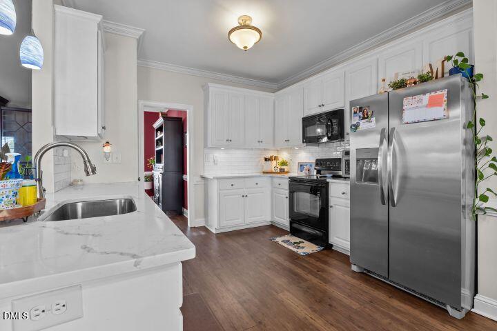 4240 Merck Road Wilson, NC 27893 - Photo 15 of 47 a kitchen with refrigerator and cabinets