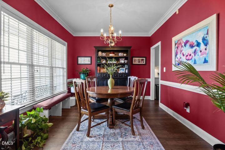 4240 Merck Road Wilson, NC 27893 - Photo 20 of 47 a view of a dining room with furniture a chandelier and a window