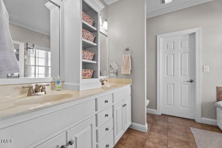 4240 Merck Road Wilson, NC 27893 - Photo 24 of 47 a bathroom with a double vanity sink a mirror and next to a window