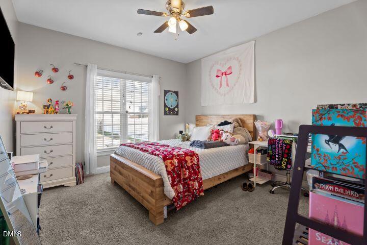 4240 Merck Road Wilson, NC 27893 - Photo 27 of 47 a bedroom with a bed and a chandelier