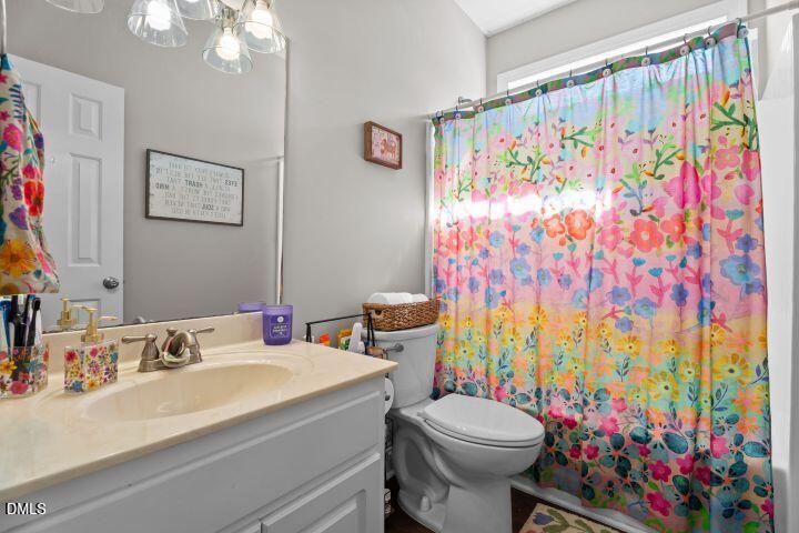 4240 Merck Road Wilson, NC 27893 - Photo 29 of 47 a bathroom with a sink a toilet and a shower curtain