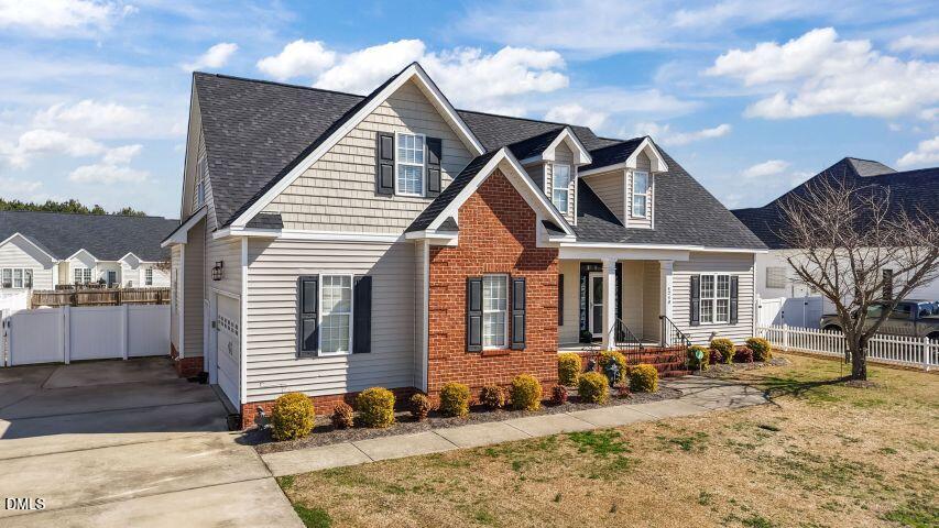 4240 Merck Road Wilson, NC 27893 - Photo 4 of 47 a view of a white house with large windows next to a yard