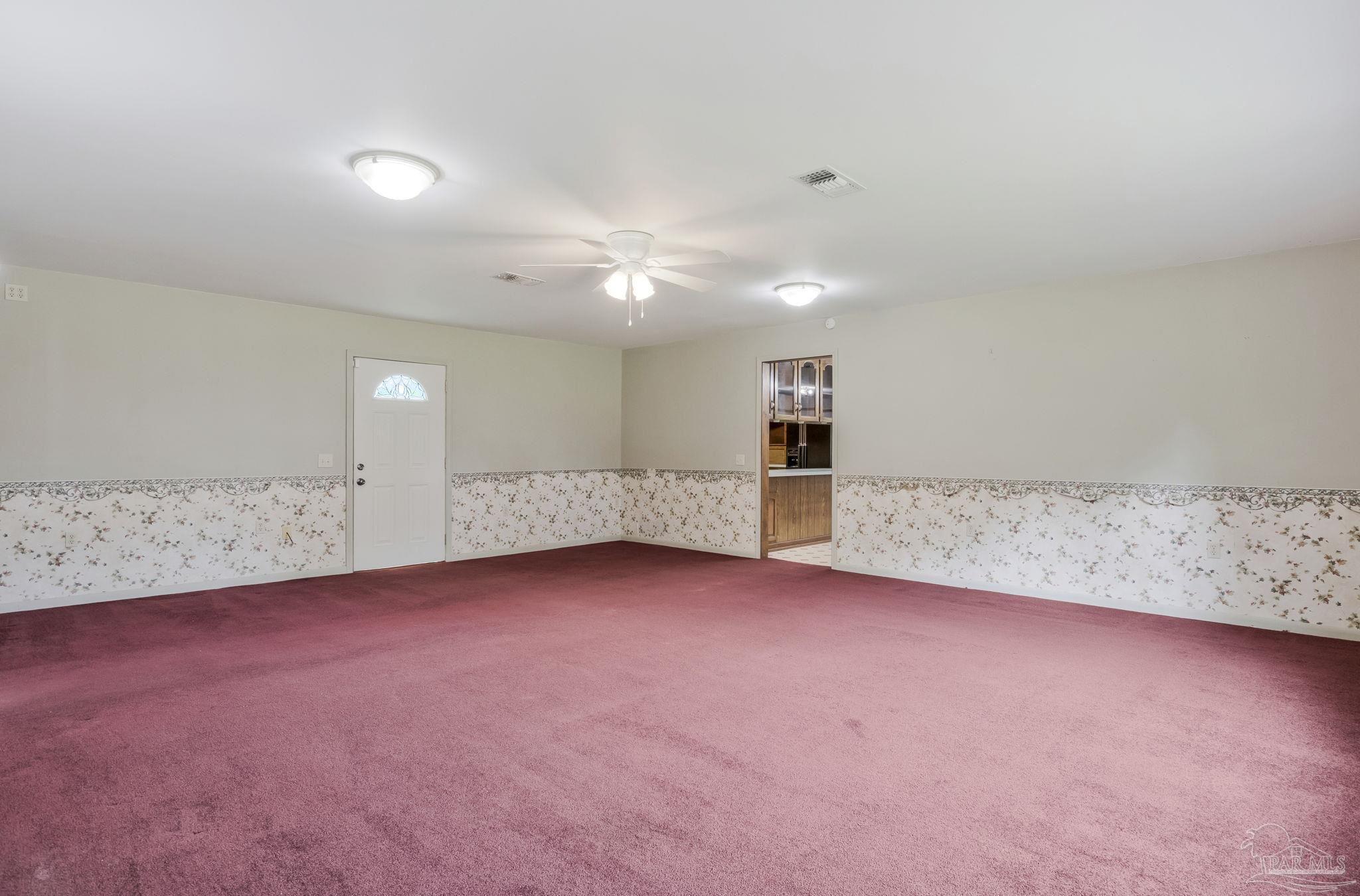 4411 Pace Lane Pace, FL 32571 - Photo 16 of 68 an empty room with windows and fireplace