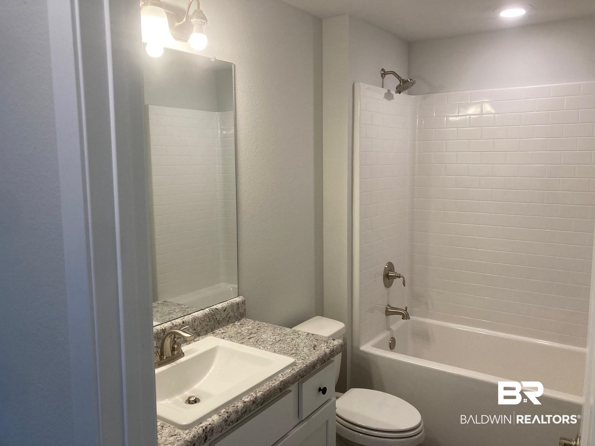 629 Revere Street Foley, AL 36535 - Photo 15 of 30 Full bathroom with vanity, toilet, and tiled shower / bath combo