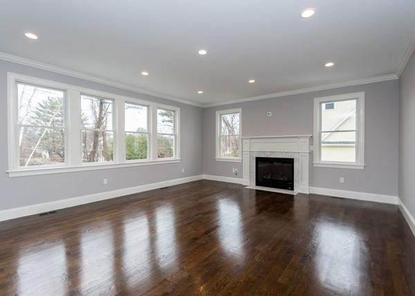 35 Sachem Road Needham, MA 02494 - Photo 7 of 21 an empty room with wooden floor fireplace and windows