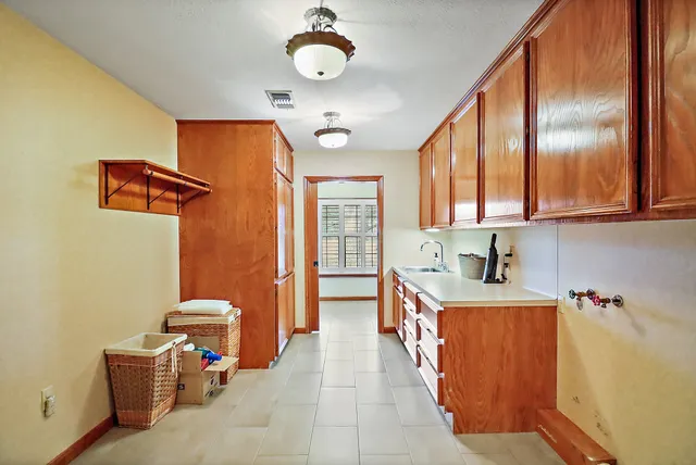 a kitchen that has a microwave a sink and a stove in it