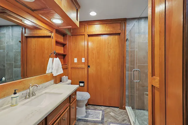 a bathroom with a mirror a sink and a shower