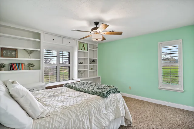 a bedroom with a large bed and a window