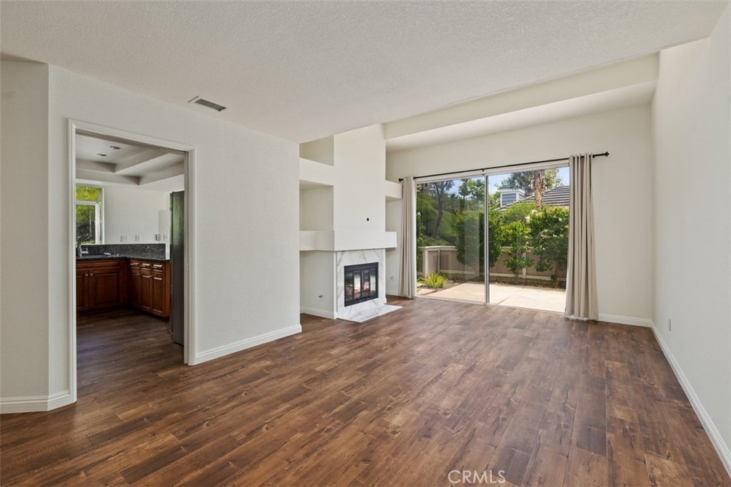 14 Pickney Close Laguna Niguel, CA 92677 - Photo 15 of 22 a view of a big room with wooden floor fireplace and a window