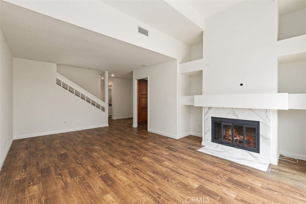 14 Pickney Close Laguna Niguel, CA 92677 - Photo 16 of 22 a view of an empty room with wooden floor fireplace and a window