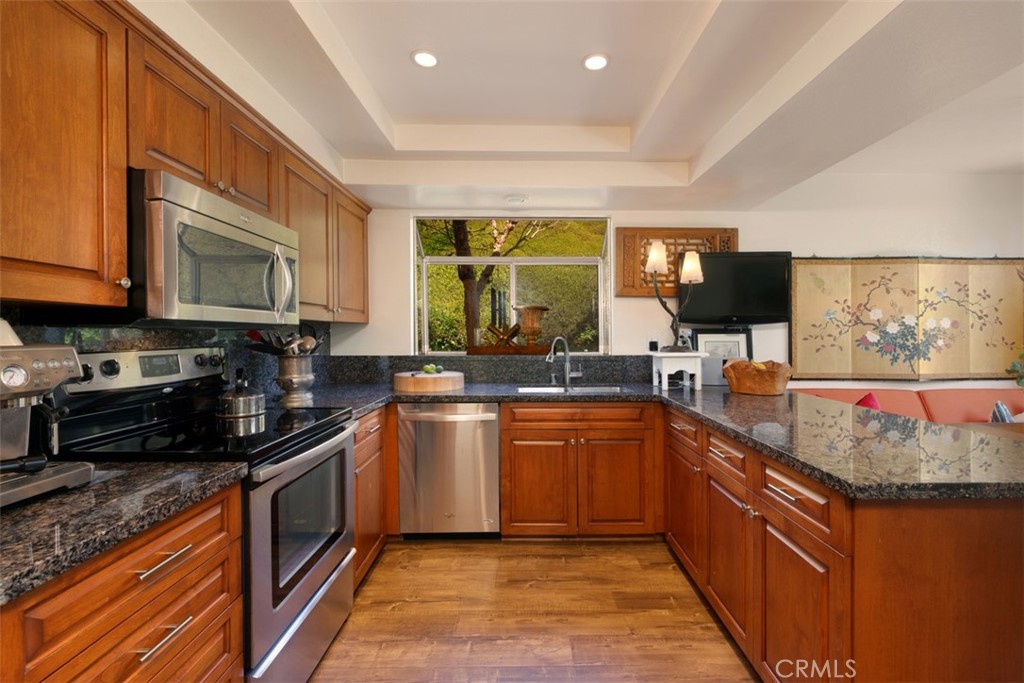 14 Pickney Close Laguna Niguel, CA 92677 - Photo 6 of 22 a large kitchen with stainless steel appliances granite countertop a stove a sink and a microwave