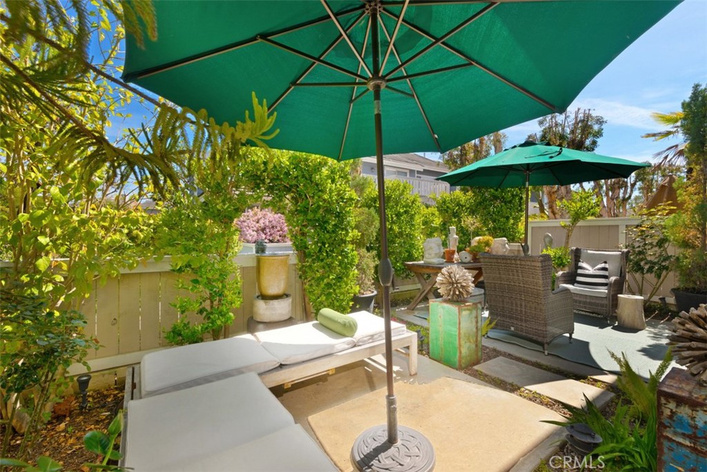 14 Pickney Close Laguna Niguel, CA 92677 - Photo 10 of 22 a patio with tables and chairs under an umbrella