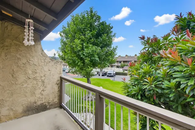 a view of a balcony with a tree