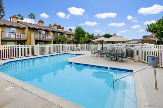 a view of a swimming pool with a patio and a garden