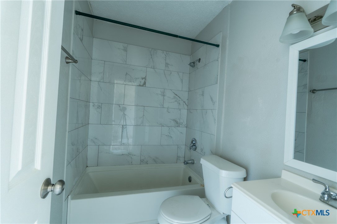 512 Sunset Lane, Unit AD Copperas Cove, TX 76522 - Photo 18 of 23 a white toilet sitting next to a bath tub and shower