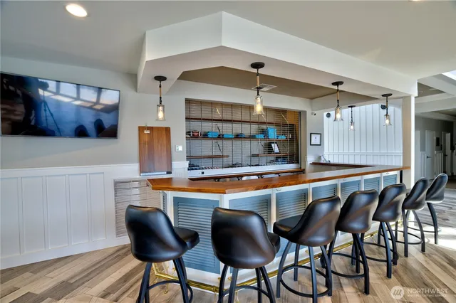 a view of a dining room with furniture large windows and wooden floor