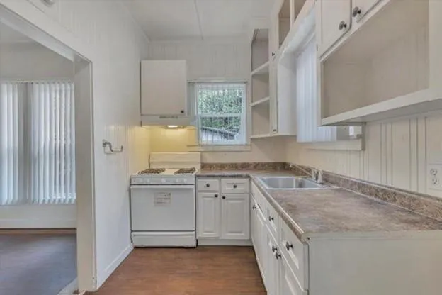 a kitchen with a sink stove and cabinets