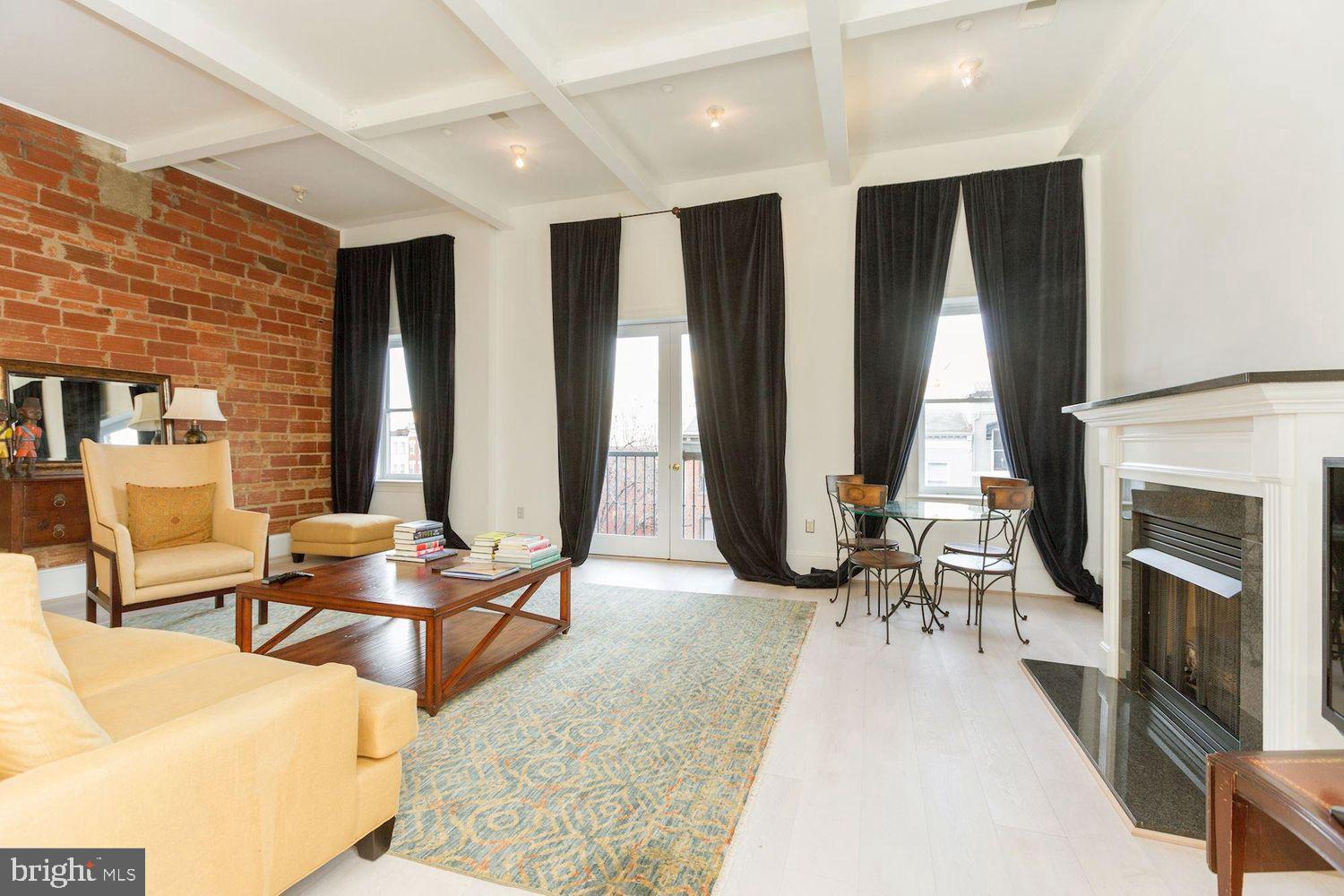 1220 N Street Northwest, Unit 4A Washington, DC 20005 - Photo 1 of 28 a living room with fireplace furniture and large windows