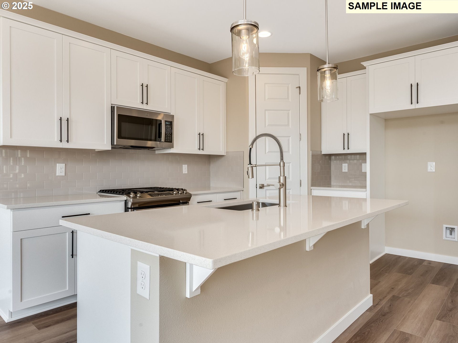 831 Northwest 178th Street Ridgefield, WA 98642 - Photo 3 of 37 a kitchen with stainless steel appliances a stove microwave and sink