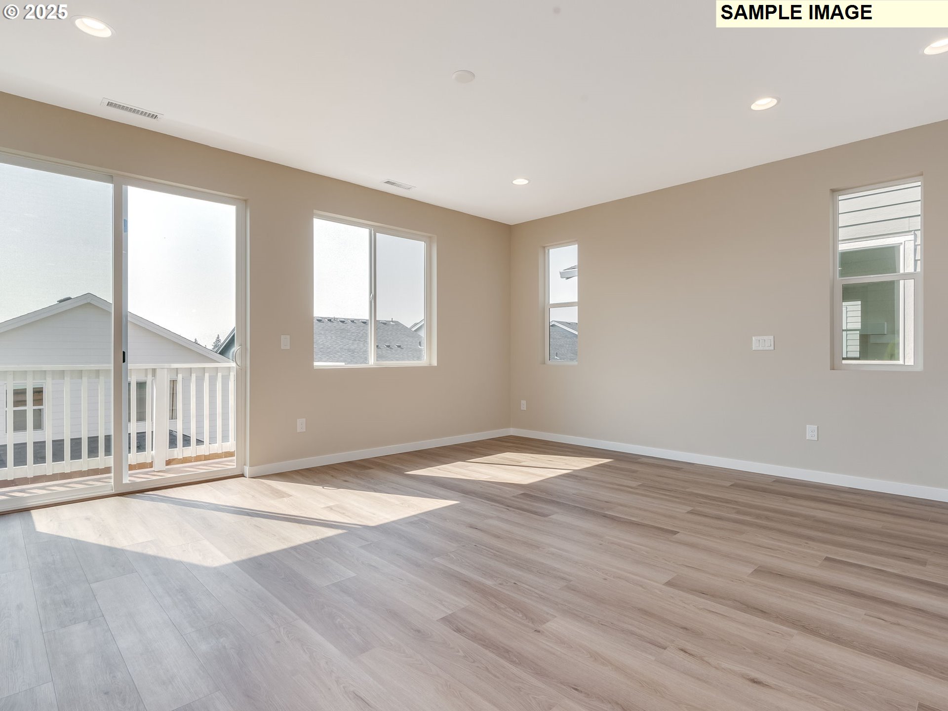 831 Northwest 178th Street Ridgefield, WA 98642 - Photo 6 of 37 an empty room with wooden floor and windows