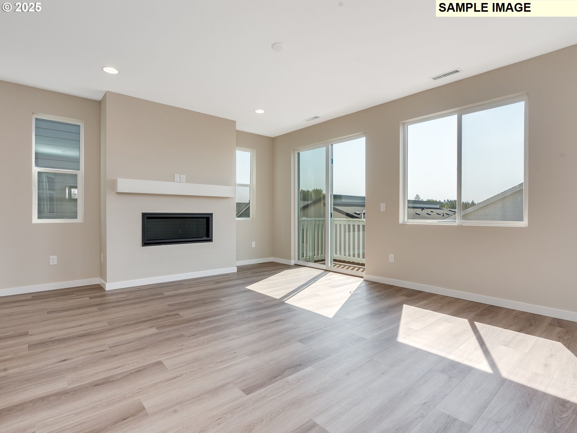 831 Northwest 178th Street Ridgefield, WA 98642 - Photo 7 of 37 an empty room with wooden floor fireplace and windows