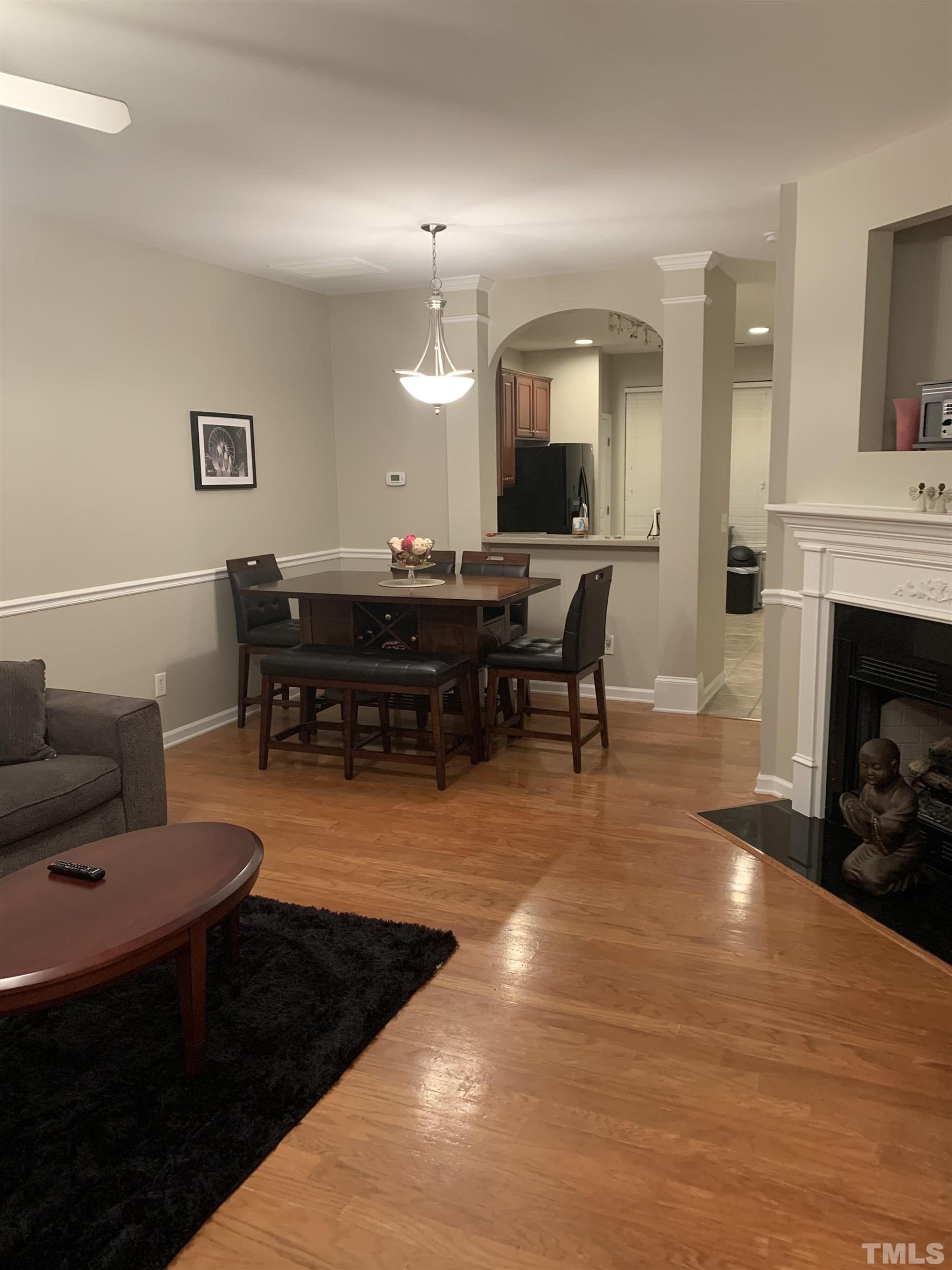 7845 Spungold Street Raleigh, NC 27617 - Photo 1 of 37 a living room with furniture a fireplace and a piano