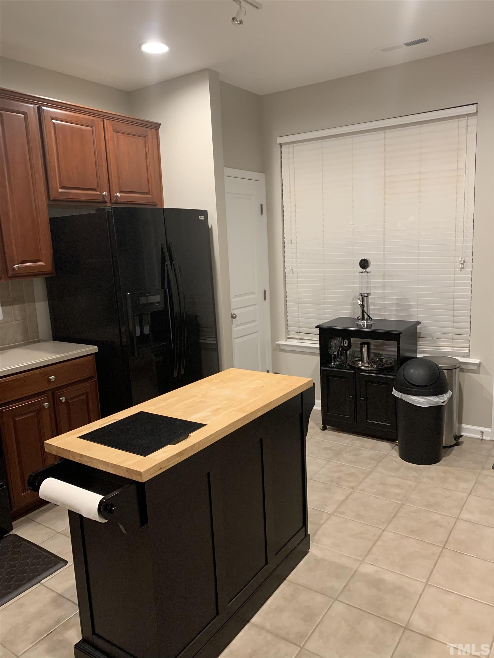 7845 Spungold Street Raleigh, NC 27617 - Photo 12 of 37 a kitchen that has a sink and a stove in it