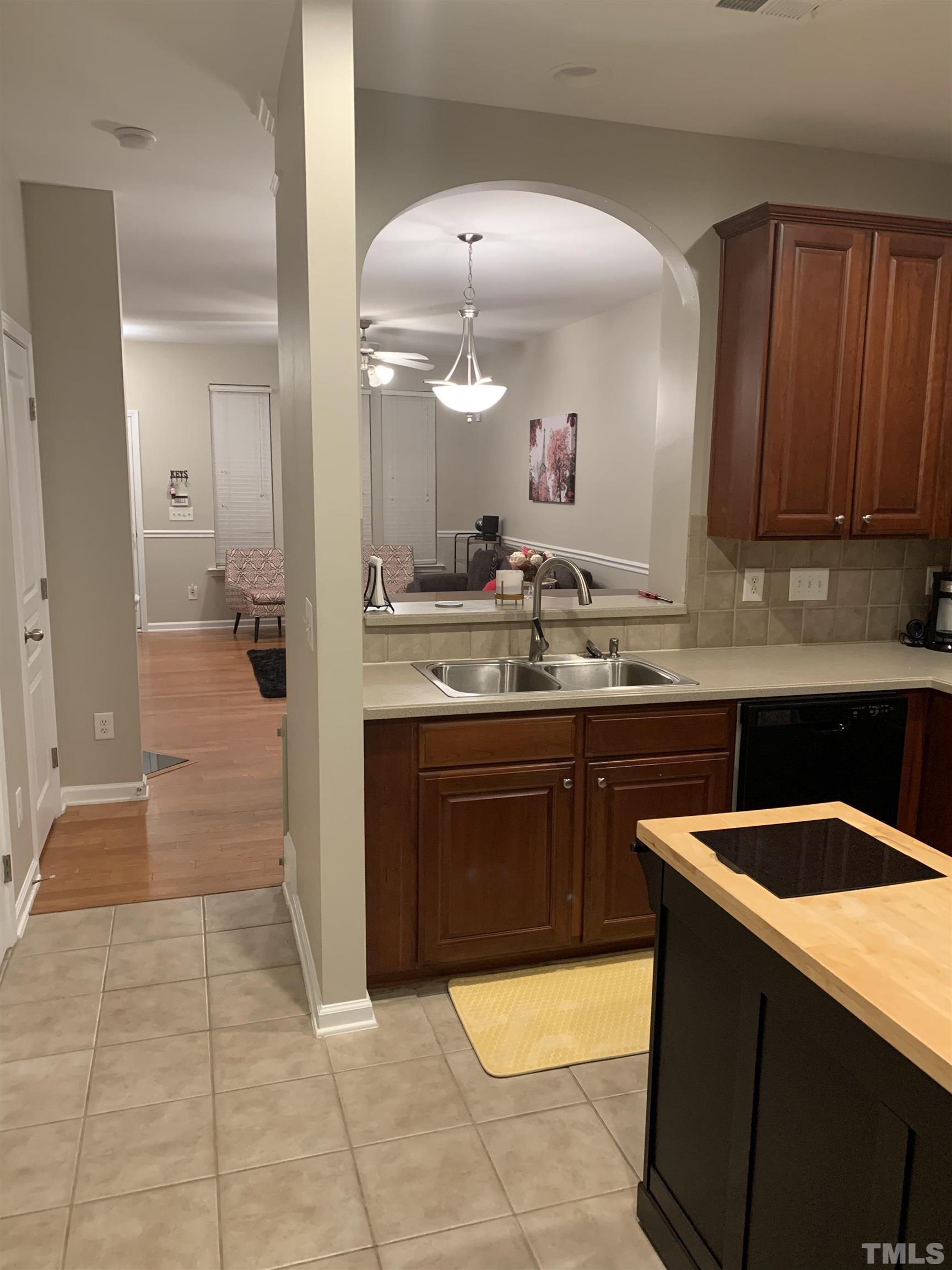 7845 Spungold Street Raleigh, NC 27617 - Photo 13 of 37 a kitchen with a sink and cabinets