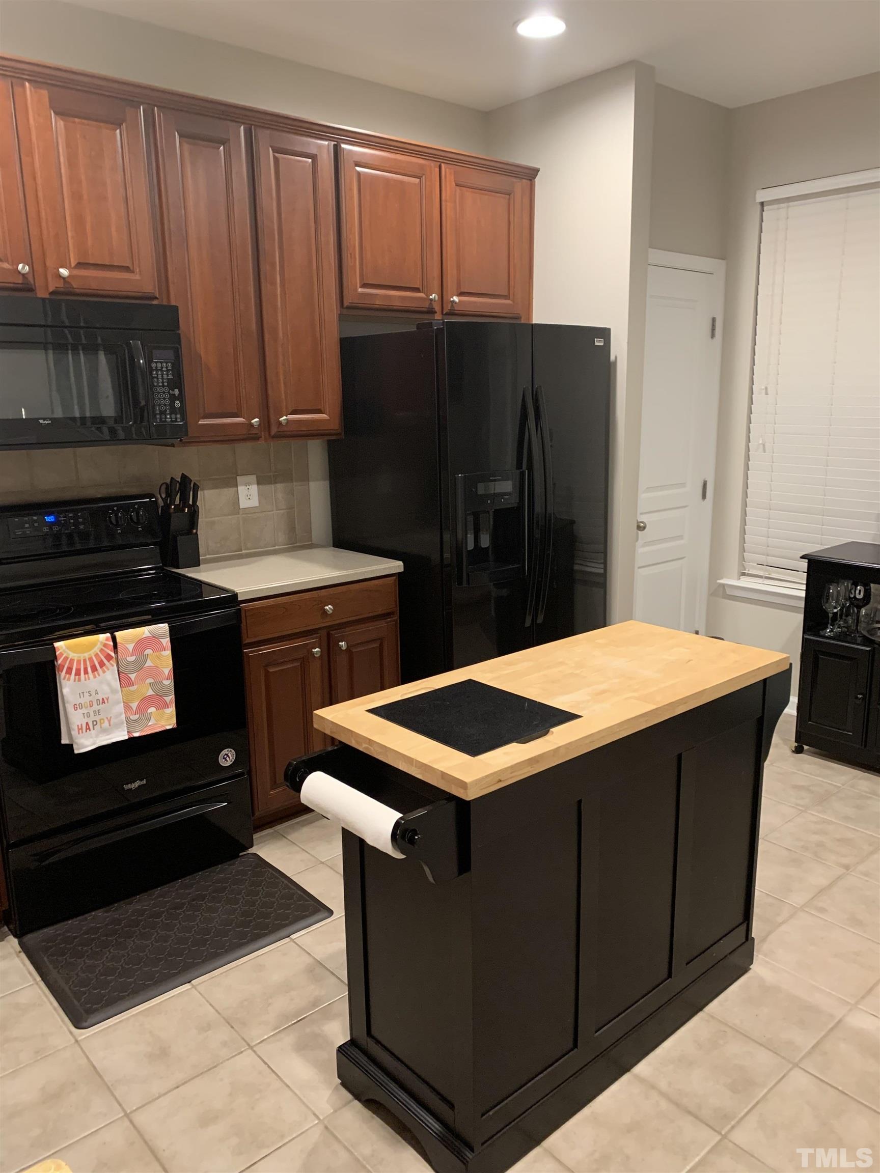 7845 Spungold Street Raleigh, NC 27617 - Photo 14 of 37 a kitchen with a sink and a refrigerator