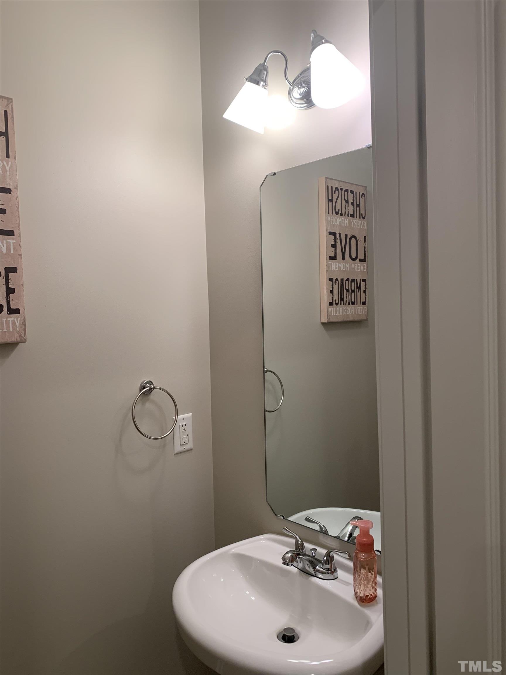 7845 Spungold Street Raleigh, NC 27617 - Photo 16 of 37 a bathroom with a sink and mirror