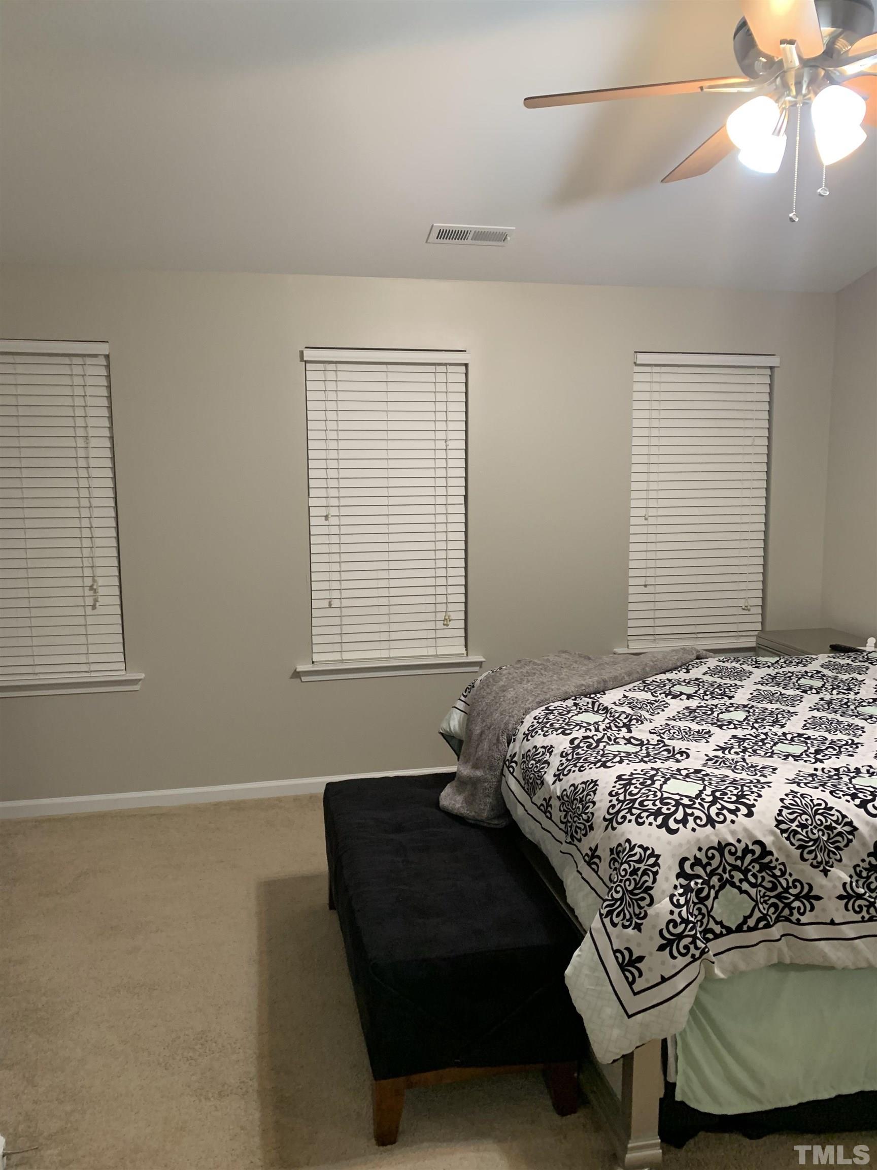 7845 Spungold Street Raleigh, NC 27617 - Photo 19 of 37 a bedroom with a bed and window