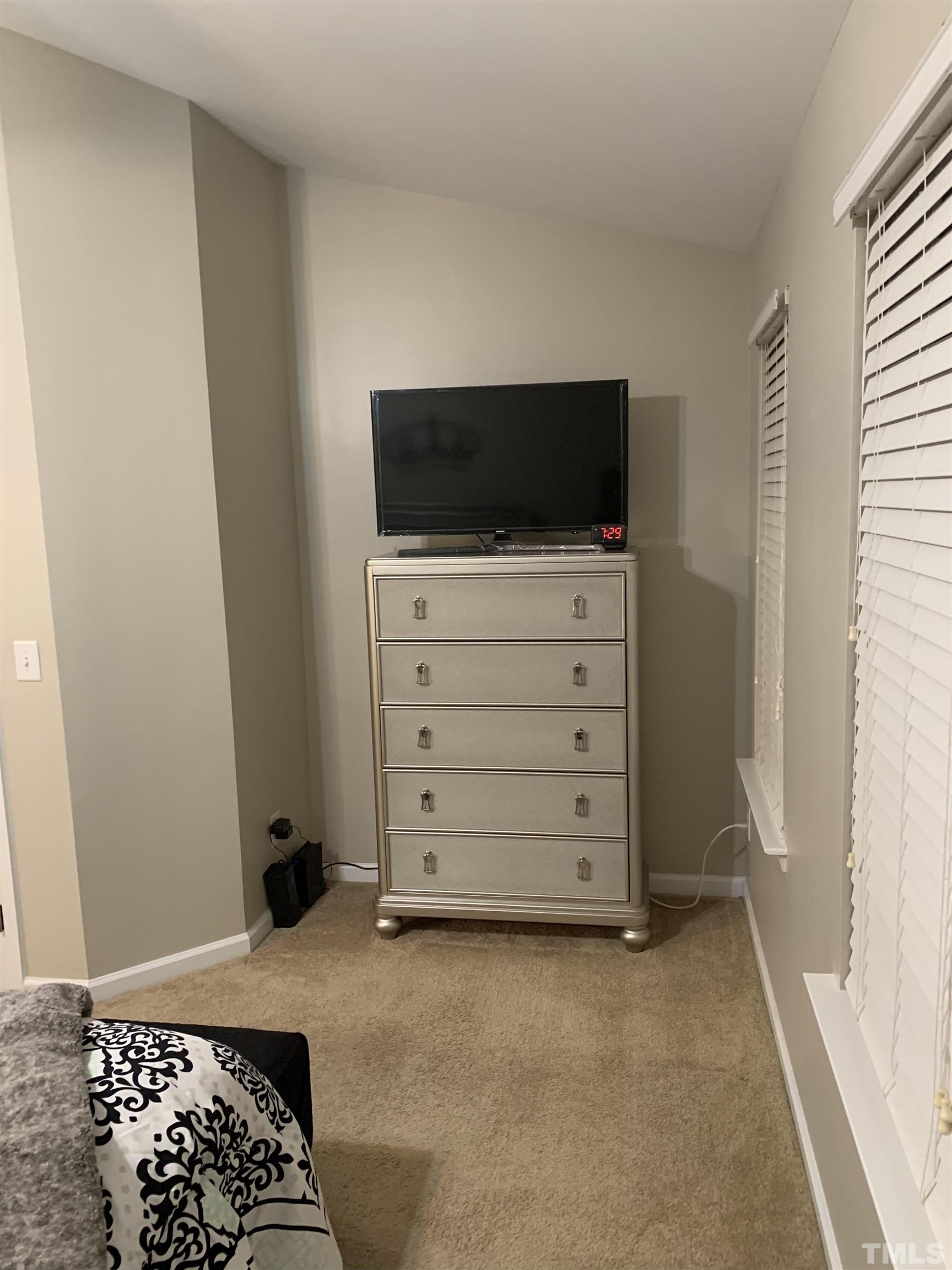 7845 Spungold Street Raleigh, NC 27617 - Photo 20 of 37 a view of bedroom with furniture and flat screen tv