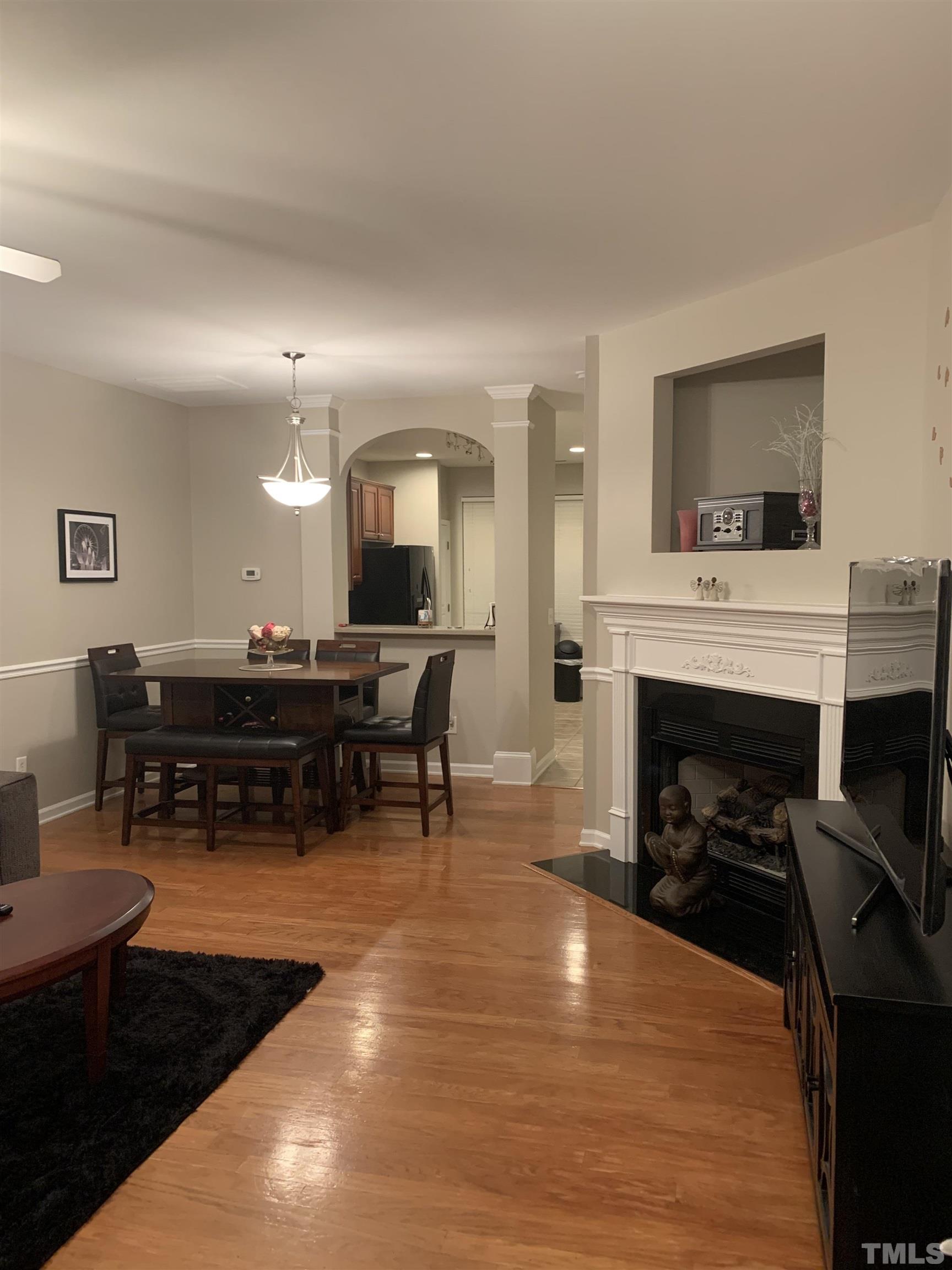 7845 Spungold Street Raleigh, NC 27617 - Photo 2 of 37 a living room with furniture and a fireplace