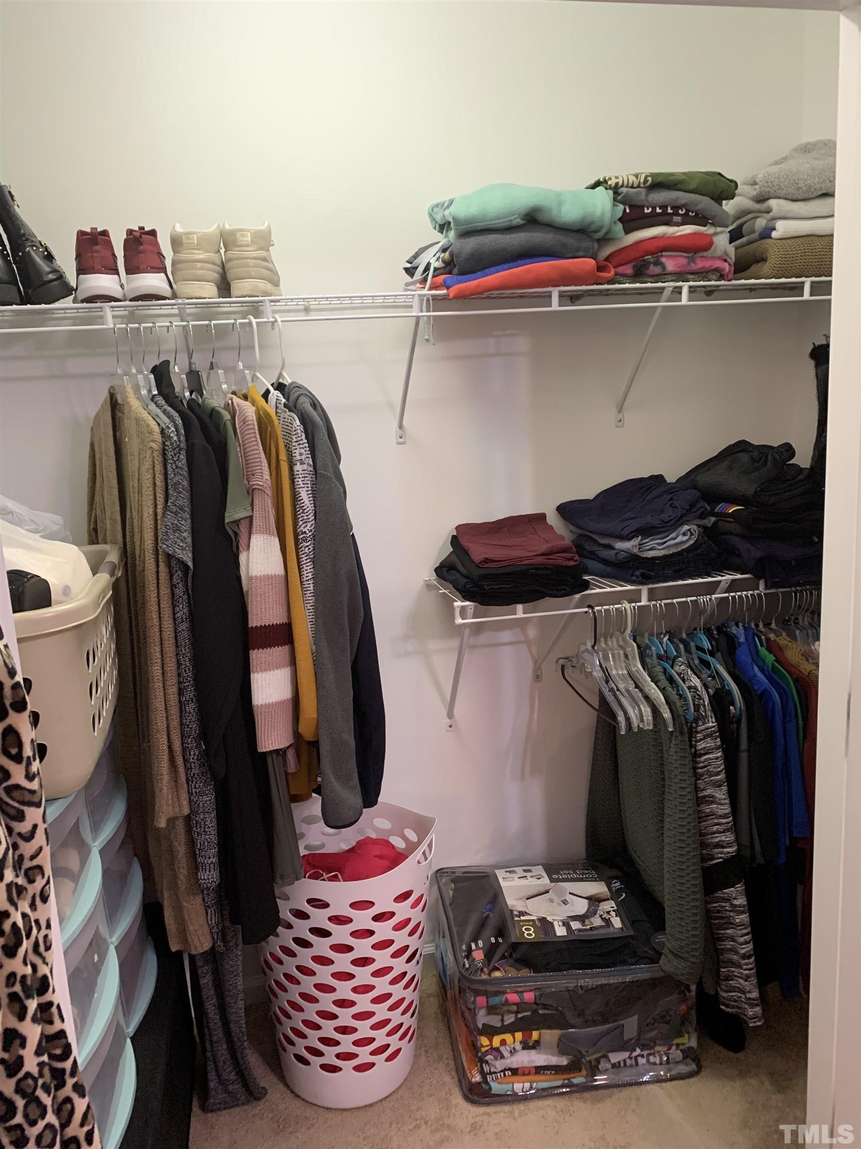 7845 Spungold Street Raleigh, NC 27617 - Photo 25 of 37 a view of walk in closet with clothes and shoes
