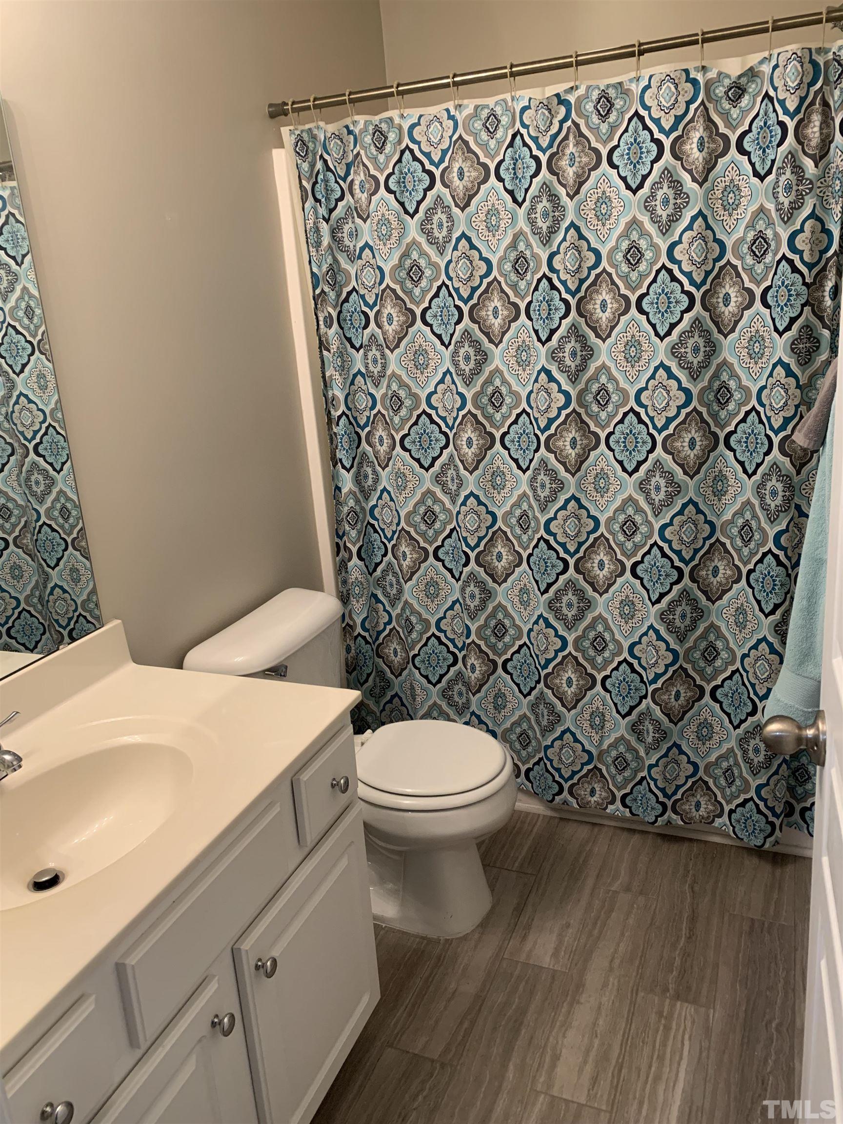 7845 Spungold Street Raleigh, NC 27617 - Photo 26 of 37 a bathroom with a granite countertop toilet and a sink