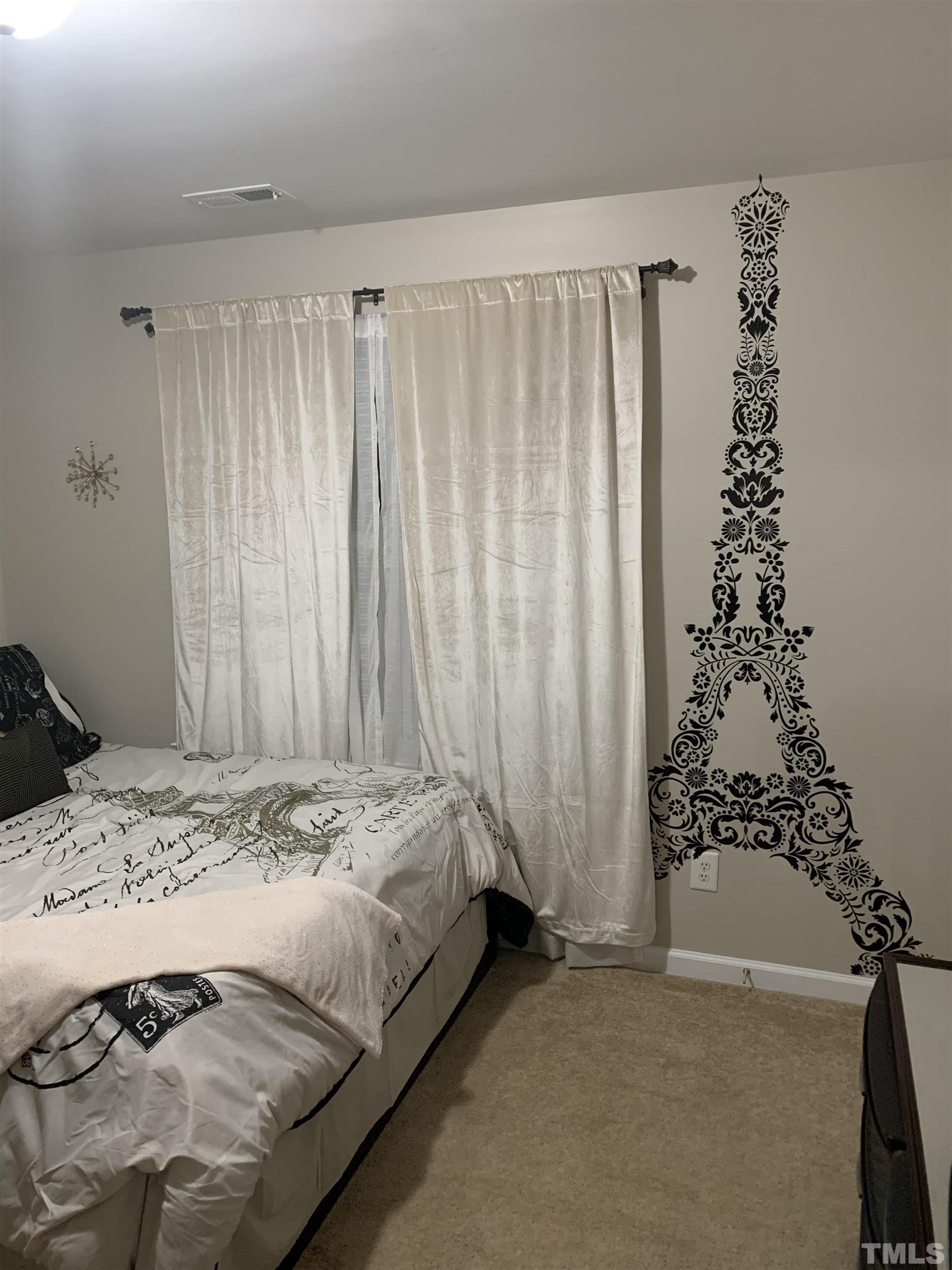 7845 Spungold Street Raleigh, NC 27617 - Photo 28 of 37 a bedroom with a bed and a window