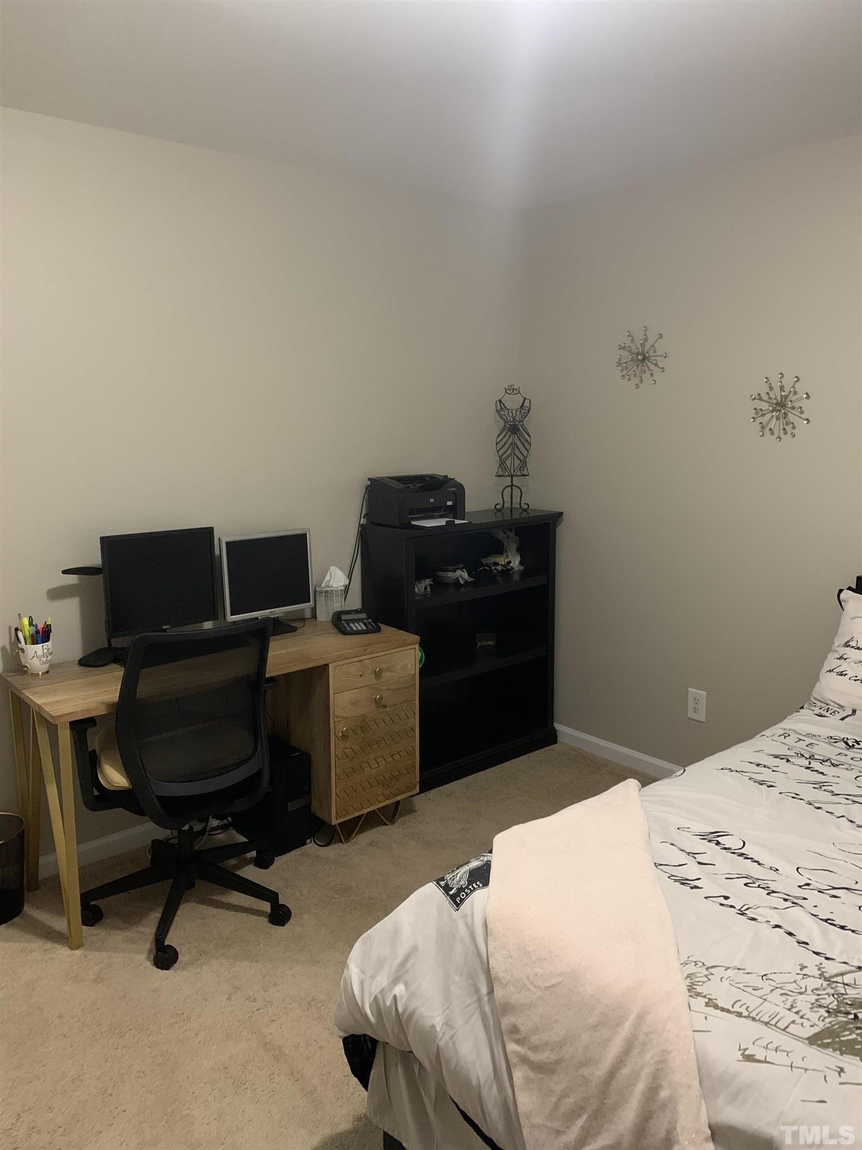 7845 Spungold Street Raleigh, NC 27617 - Photo 30 of 37 a bedroom with a bed and a chair