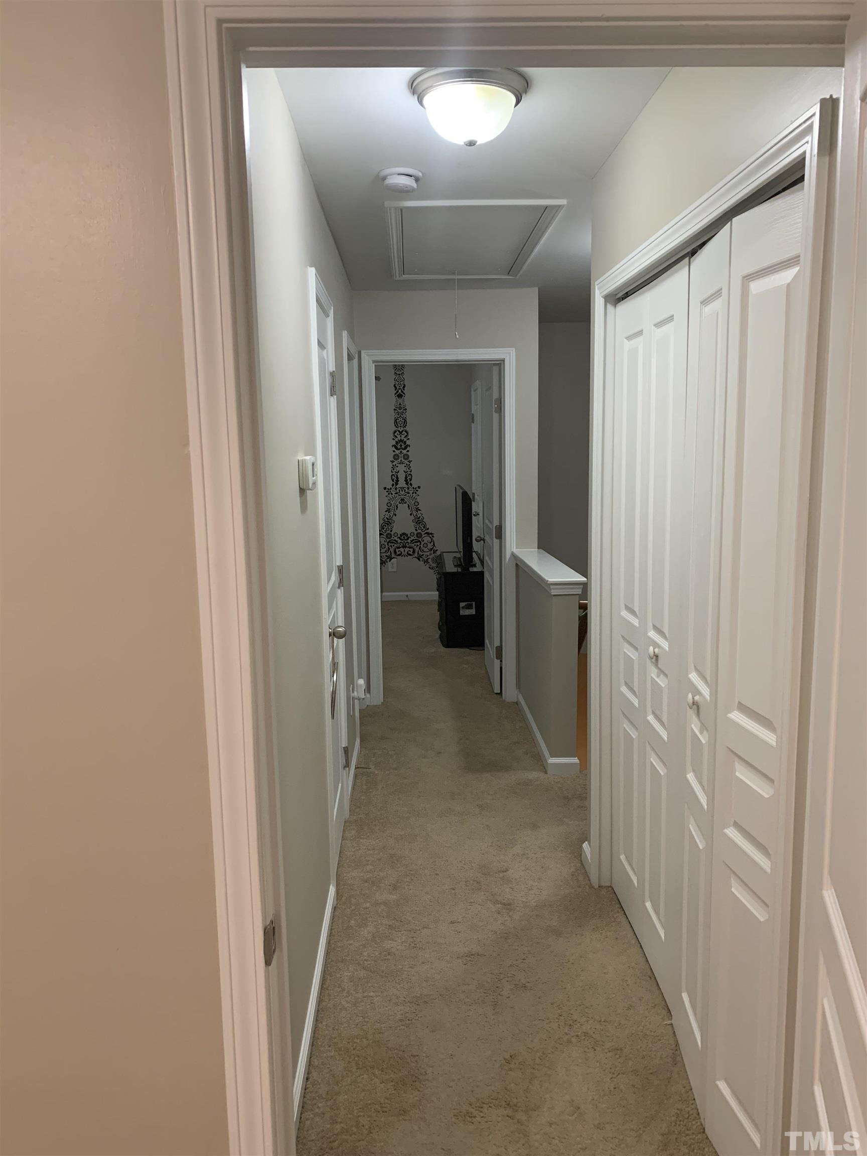 7845 Spungold Street Raleigh, NC 27617 - Photo 31 of 37 a view of a hallway with living room and furniture