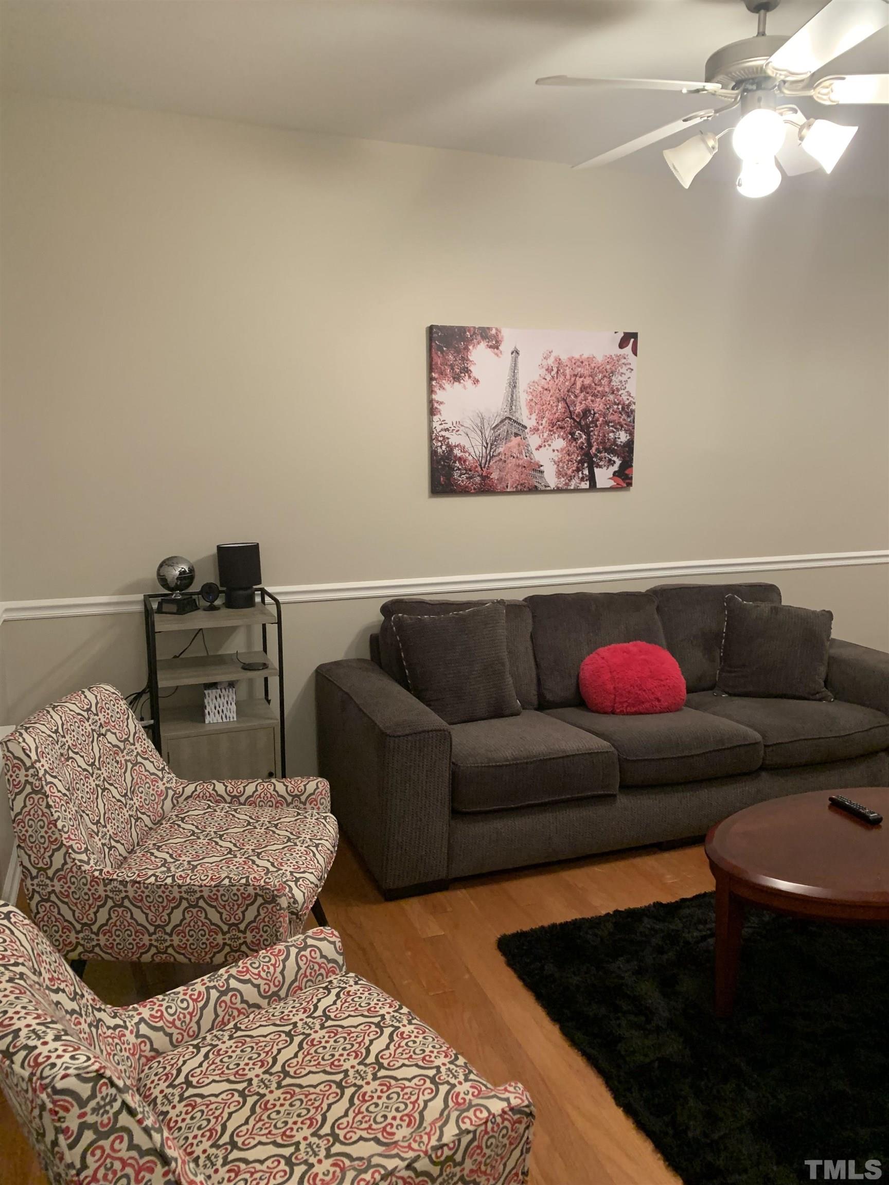 7845 Spungold Street Raleigh, NC 27617 - Photo 4 of 37 a living room with furniture and a couch