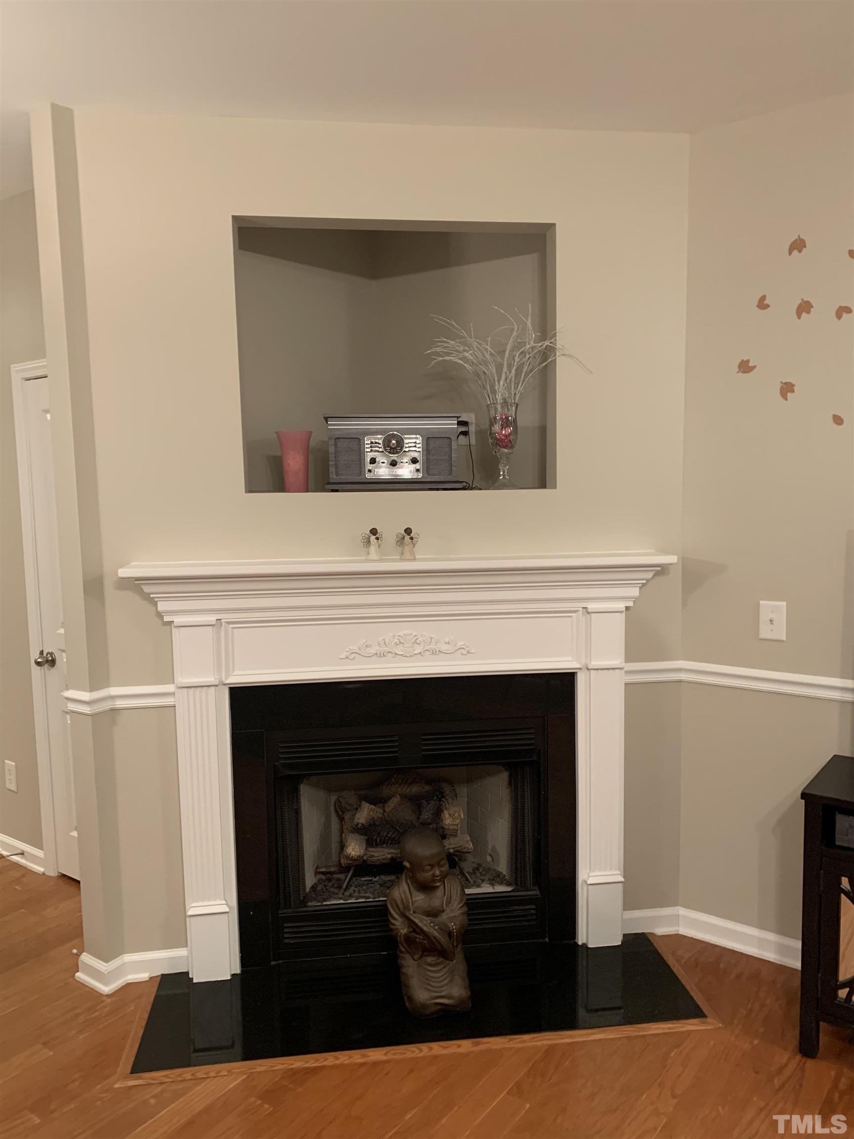 7845 Spungold Street Raleigh, NC 27617 - Photo 5 of 37 a living room with a fireplace