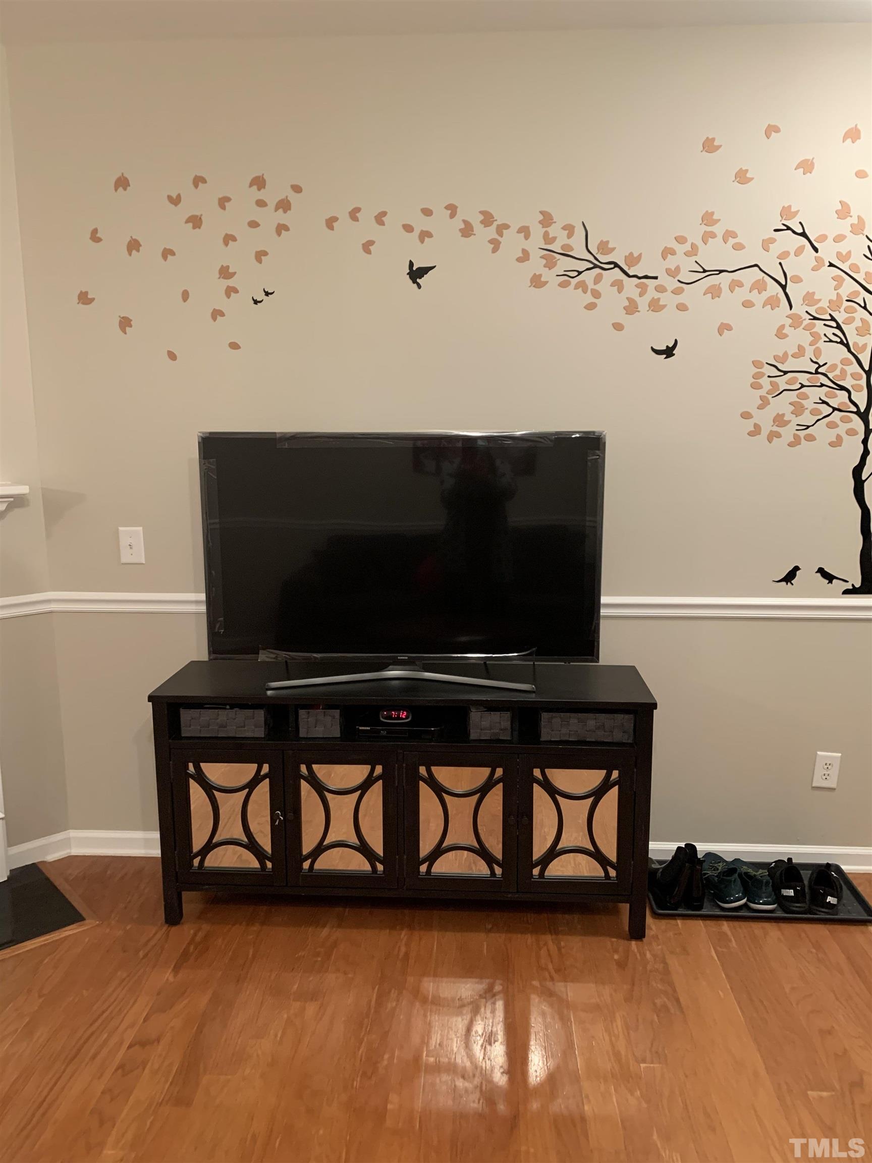 7845 Spungold Street Raleigh, NC 27617 - Photo 6 of 37 a living room with furniture and a flat screen tv